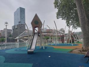 a playground with a slide in a city at Bilbao Center Apt PARKING in Bilbao