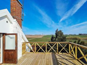 una terraza de madera con una puerta de madera en un edificio en 6 person holiday home in SIMRISHAMN en Simrishamn