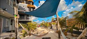 a hammock in front of a building at Costa Nube in Caye Caulker
