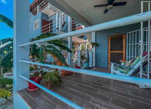 a front porch of a house with plants at Costa Nube in Caye Caulker