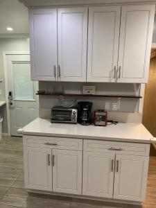 a kitchen with white cabinets and a counter top at Private Room in Los Angeles LA with TV & WIFI & AC & View of Hollywood Sign & Private Fridge & Shared Kitchen!!! in Los Angeles