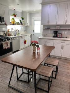 a kitchen with a wooden table in a kitchen at Private Room in Los Angeles LA with TV & WIFI & AC & View of Hollywood Sign & Private Fridge & Shared Kitchen!!! in Los Angeles