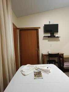 a white shirt is on a bed in a room at Pousada Águas do Jalapão in Ponte Alta do Tocantins