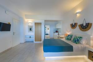 a bedroom with a bed and a living room at La Mer Seaside Apartments in Drios