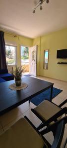 a living room with a table and chairs at Galini Apartments in Litochoro