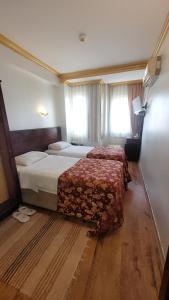 Postel nebo postele na pokoji v ubytování MEHMET BEY HOTEL