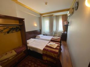 Postel nebo postele na pokoji v ubytování MEHMET BEY HOTEL