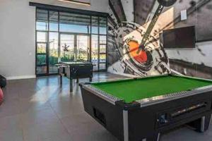a gaming room with a pool table and a mural at Greenpark Lifestyle Estate in Boksburg