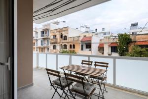 a table and chairs on a balcony with a view at Modern 3BR Stylish Apartment with large Balcony - Close to St Julians and St Georges Bay in Is-Swieqi