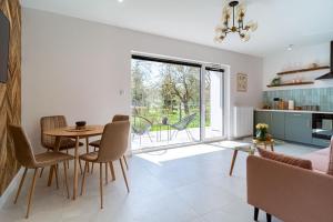 a kitchen and dining room with a table and chairs at Apartament J&T Mrągowo in Mrągowo