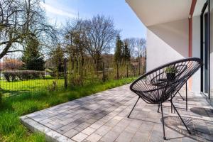 a bench sitting on a patio next to a building at Apartament J&T Mrągowo in Mrągowo