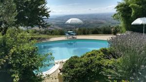 a swimming pool with a view of the countryside at Case Leonori in Treia