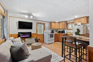 a living room with a couch and a kitchen at Mountainscape Cabins 1 in Thornton