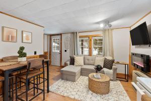 a living room with a couch and a table at Mountainscape Cabins 1 in Thornton
