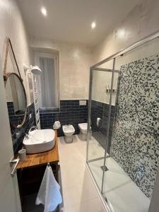 a bathroom with a shower and a sink and a toilet at Santorio 5 Apartment in Trieste