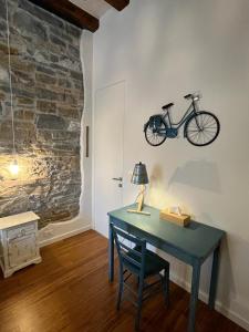 a desk with a bike hanging on a wall at Santorio 5 Apartment in Trieste