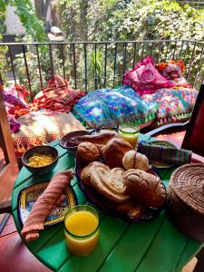 a table with a tray of bread and other foods at Boutique hotel and gallery in San Angel Inn in Mexico City