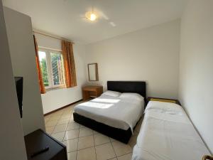 Postel nebo postele na pokoji v ubytování Hotel Nuova Barcaccia