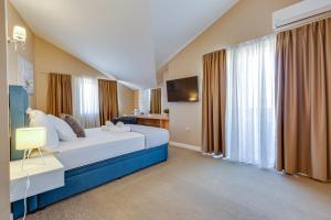 a hotel room with a bed and a television at Hotel Sky in Zadar