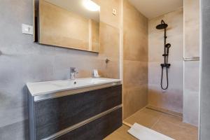 a bathroom with a sink and a shower at Hotel Sky in Zadar