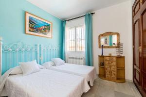 two beds in a room with blue walls at Star's House Sevilla.Con piscina,10 min de Sevilla in Valencina de la Concepción +42 photos