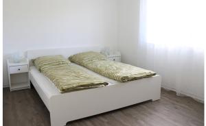 a white bed with two pillows on top of it at FeWo Rodalben Pfalz in Rodalben