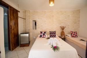 a room with a bed with a stuffed animal on it at Pousada do Mel in Arraial d'Ajuda +55 photos