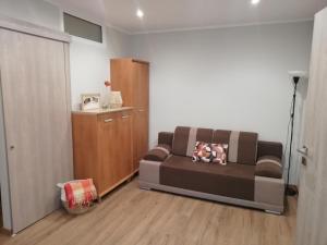 ein Wohnzimmer mit einem Sofa und Holzboden in der Unterkunft Mieszkanie na Mazurach in Giżycko