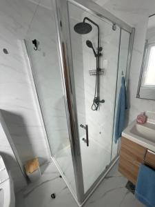 a shower with a glass door in a bathroom at Studio Galija in Poreč