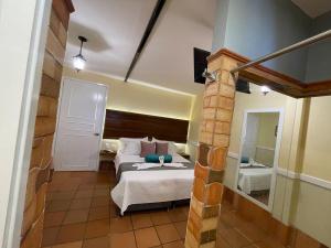 a bedroom with a bed and a large mirror at HOTEL CAMPESTRE MANOA in Rivera