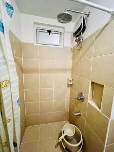 a bathroom with a shower with a toilet in it at 1 BR Condo Unit at The Celandine Condominium near Ayala Cloverleaf Mall in Manila