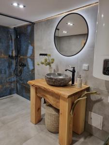 a bathroom with a sink and a mirror at Wiejska Chata in Barczewo