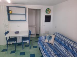 a living room with a table and a couch at Villa la Torre Levante in Torre Dei Corsari