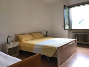 a bedroom with a large bed and a window at Casa Silvia in Ledro