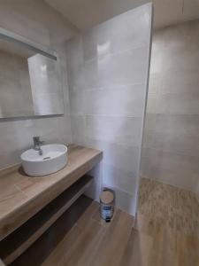 a white bathroom with a sink and a mirror at Les Amarres belle maison 1,5km de la plage in Saint-Denis-dʼOléron