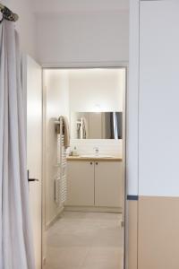 a bathroom with a sink and a mirror at L Hirondelle et l Instant in Dolus d'Oléron