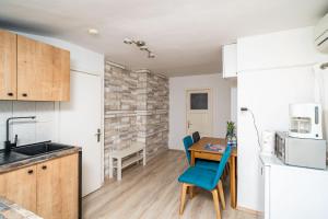 a kitchen and dining room with a table and chairs at Magnolia Apartments, Dubrovnik in Dubrovnik