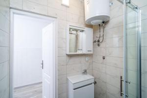a bathroom with a toilet and a glass shower door at Magnolia Apartments, Dubrovnik in Dubrovnik +53 photos