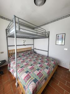 a bedroom with a bed with a metal bed frame at Solaris18 in Marina di Campo