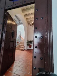 a wooden door in a room with stairs at La Chambre Bleue Chipiona in Chipiona