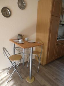 a small table and chairs in a kitchen at Holiday Home Martina in Dresden