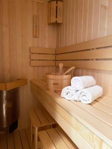 a sauna with two towels sitting on a shelf at Apartament Błękitne Spa in Ustrzyki Dolne