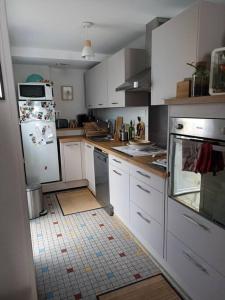 a kitchen with white cabinets and a white refrigerator at B&B during the 24Hours week / Le Mans Legend in Le Mans