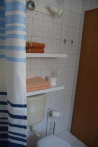 a bathroom with a toilet and towels on the wall at Holiday Home Martina in Dresden +8 photos