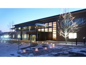 a building with lights in front of it in the snow at Japanese Auberge Plaza Ryokufu Natural Hot Spring - Vacation STAY 03280v in Shimo-orube