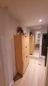 a room with a large wooden dresser in a room at Spacious 2 bedroom flat in Baker street in London