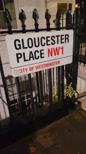 a sign on a fence in front of a building at Spacious 2 bedroom flat in Baker street in London