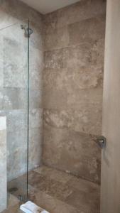 a shower with a glass door in a bathroom at Hotelito del Mar Playa del Carmen in Playa del Carmen