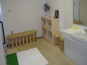 a bathroom with a sink and a toilet and a fan at Japanese Auberge Plaza Ryokufu Natural Hot Spring - Vacation STAY 03209v in Shimo-orube