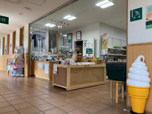 a store with an ice cream cone in the aisle at Japanese Auberge Plaza Ryokufu Natural Hot Spring - Vacation STAY 03265v in Shimo-orube